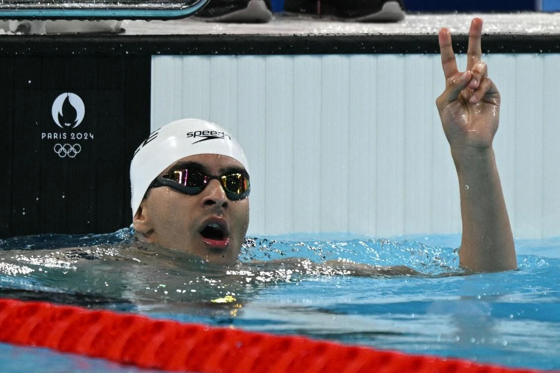 Palestine's Yazan Al Bawwab reacts after a heat of the men's 100m backstroke swimming event during the Paris 2024 Olympic Games at the Paris La Defense Arena in Nanterre, west of Paris, on July 28, 2024. (AFP)