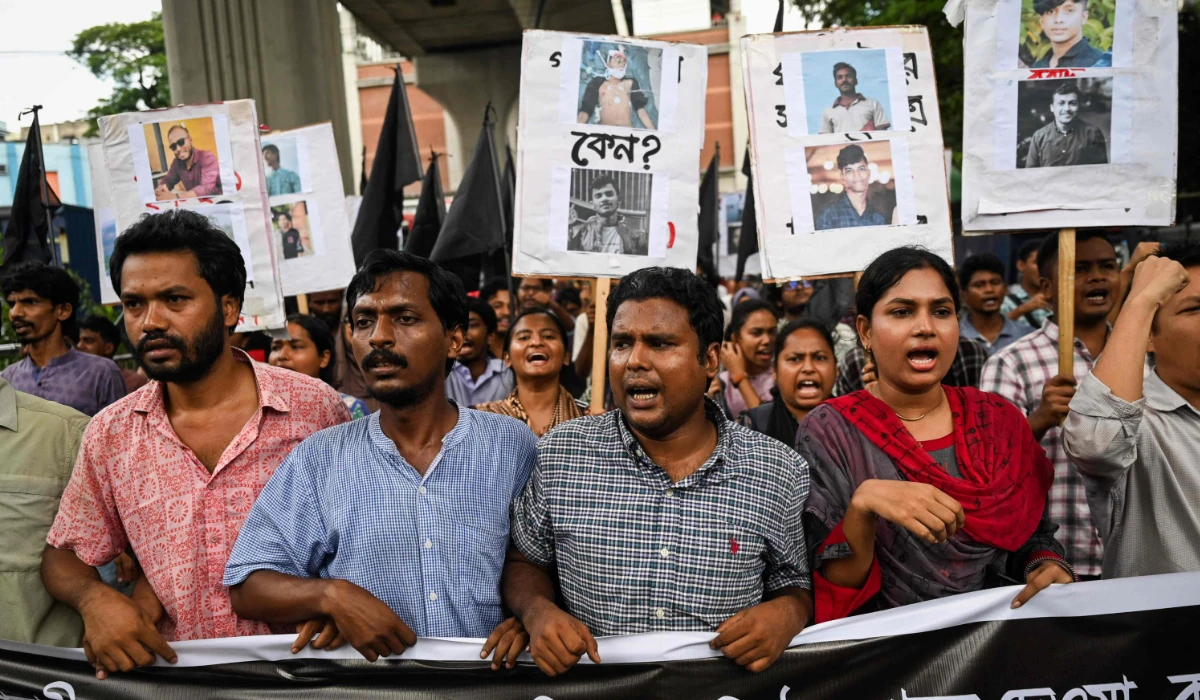 People take part in a protest march against the mass arrest and killing of protesters during last week's violence amid anti-qouta protests, in Dhaka on July 28, 2024. (AFP)