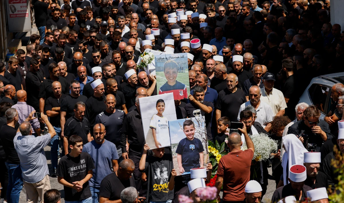 Elders and mourners carry the coffin of Guevara Ibrahim, 11, killed in a reported strike from Lebanon two days earlier, during his funeral in the town of Majdal Shams in the Israeli-annexed Golan on July 29, 2024. (AFP)