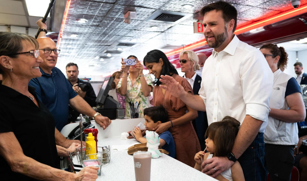 Republican vice presidential nominee U.S. Sen. J.D. Vance (R-OH) and his family greet supporters at the Park Diner on July 28, 2024 in St Cloud, Minnesota. (AFP)