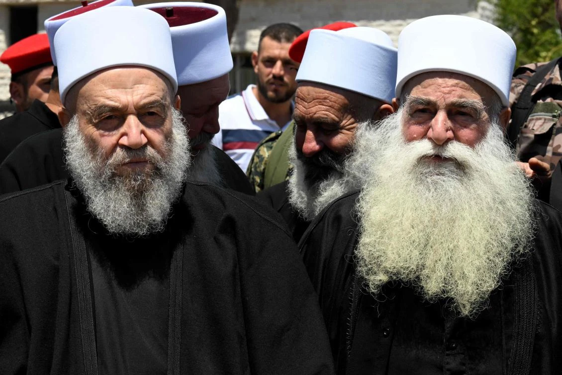 Elderly members of the Druze community gather in solidarity with the victims of the attack in Majdal Shams, on July 30, 2024, in the Syrian town of Quneitra, close to the Israeli-annexed Golan Heights. (AFP)