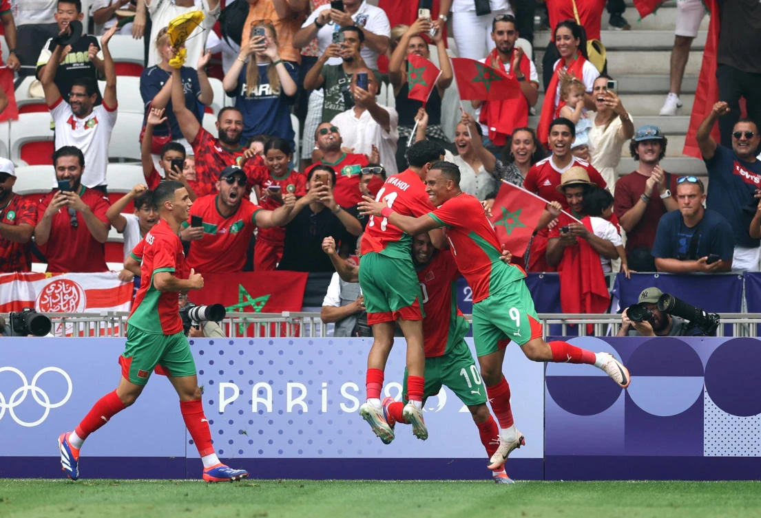 Soufiane Rahimi of Morocco celebrates scoring their second goal with Ilias Akhomach and Zakaria El Ouahdi in the Olympics Football. (Reuters)