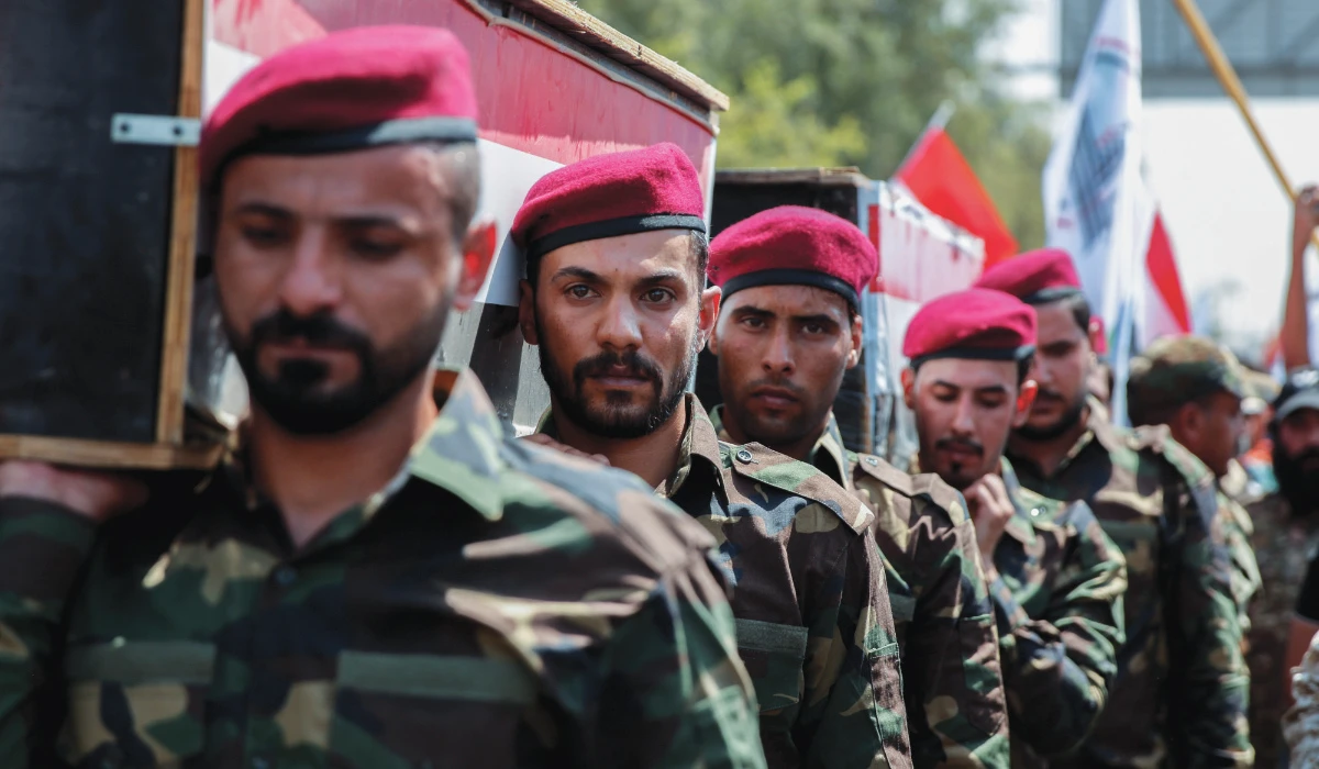 Members of Iraqi Popular Mobilization Forces (PMF) carry the mock coffins of fellow members of PMF, who were killed by US air strikes on the Syria-Iraq border, during a symbolic funeral in Baghdad, Iraq, June 29, 2021. (REUTERS file photo)