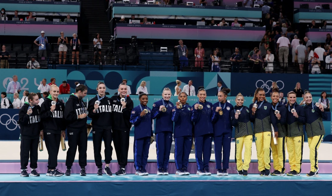 Gold medalists US team of Simone Biles, silver medalists Manila Esposito's Italy and bronze medalists Rebeca Andrade's Brazil during the podium ceremony for the women's team gymnastics competition of the Paris Olympics at the Bercy Arena on Tuesday. (Reuters)