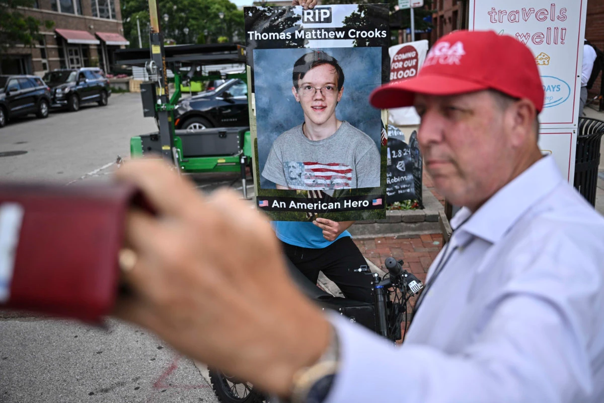 A man takes a selfie of a poster of Thomas Matthew Crooks, the 20-year-old who tried to assassinate Donald Trump. (AP)