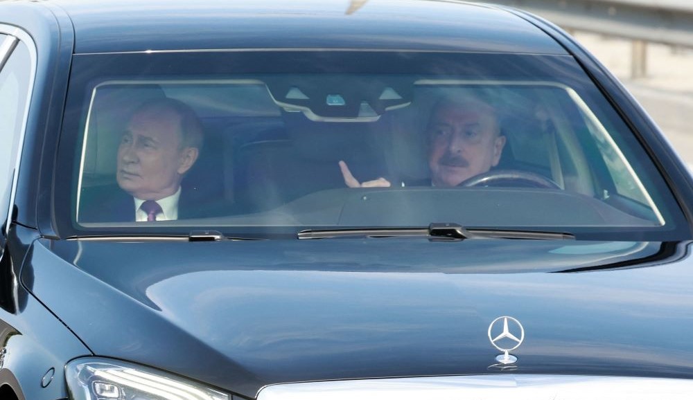 Azerbaijan’s President Ilham Aliyev takes Vladimir Putin for a drive following talks in Baku, Aug. 19, 2024. (AFP)