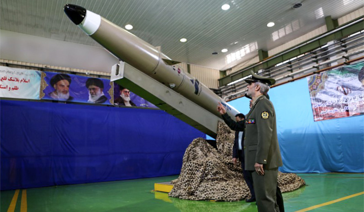 A handout picture released by Iran's Defence Ministry on August 13, 2018 shows Defence Minister, Brigadier General Amir Hatami, standing by the next generation short-range ballistic missile "Fateh Mobin", during an unveiling ceremony in the capital Tehran. (AFP)