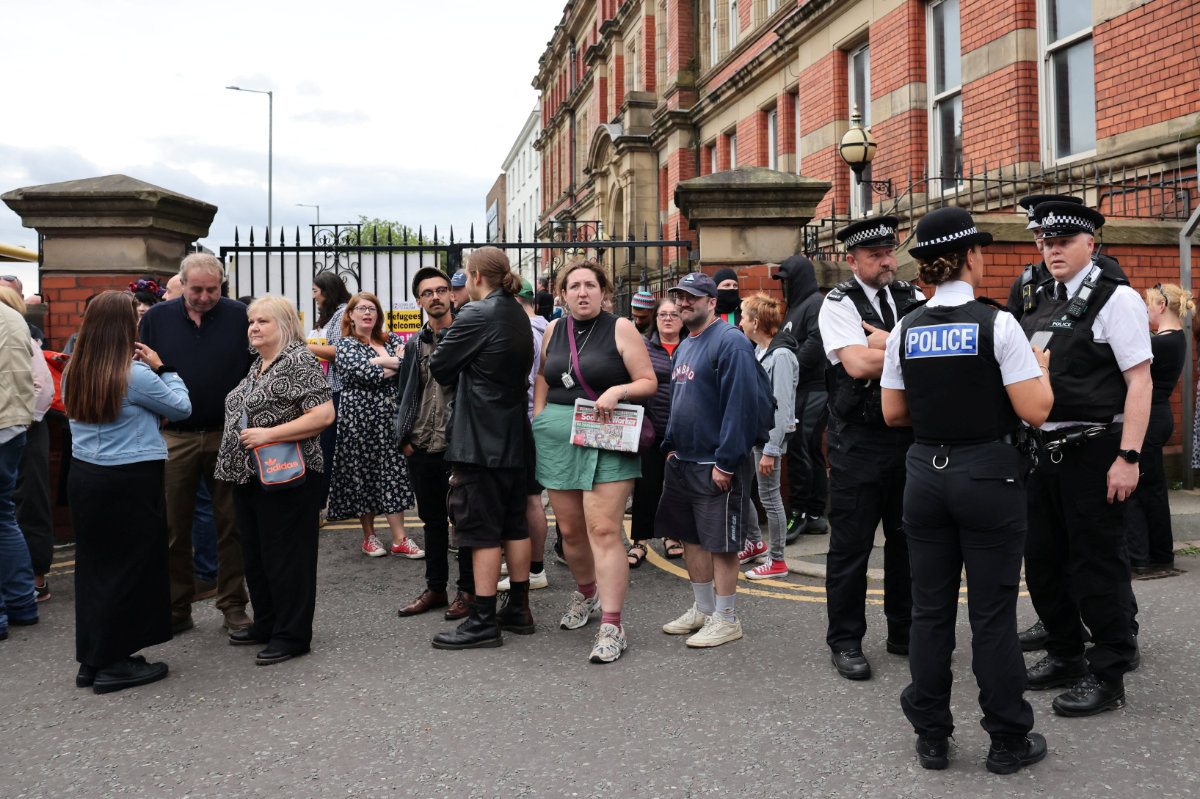 People take part in a protest outside a mosque in Liverpool, UK, on August 2, 2024. (REUTERS)