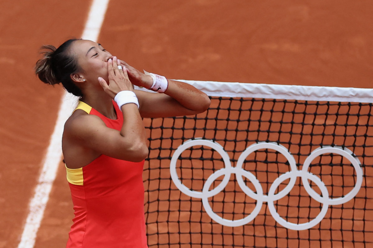 Qinwen Zheng of China celebrates after winning gold against Donna Vekic of Croatia. (REUTERS)