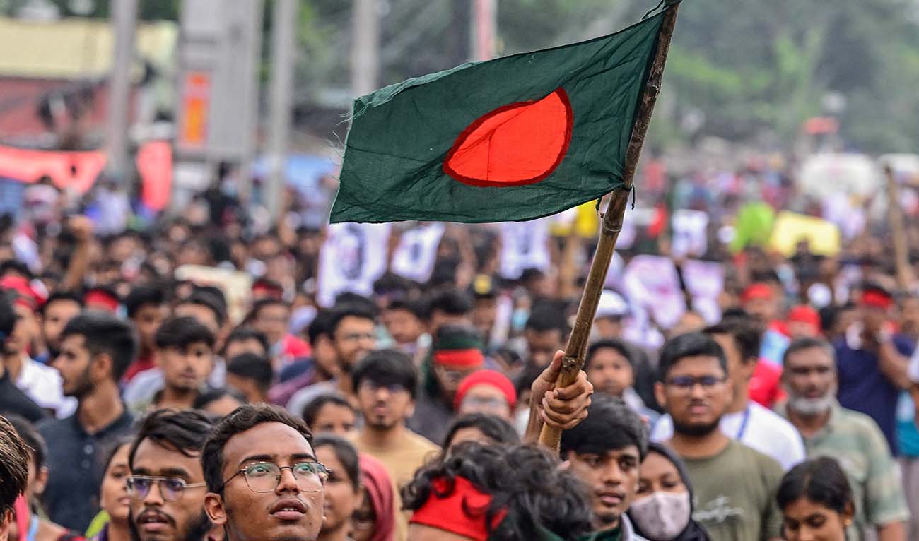A student carrying Bangladesh national flag takes part in a protest march as protesters demand justice for victims arrested and killed in the recent nationwide violence over job quotas, in Dhaka on August 3, 2024. (AFP)
