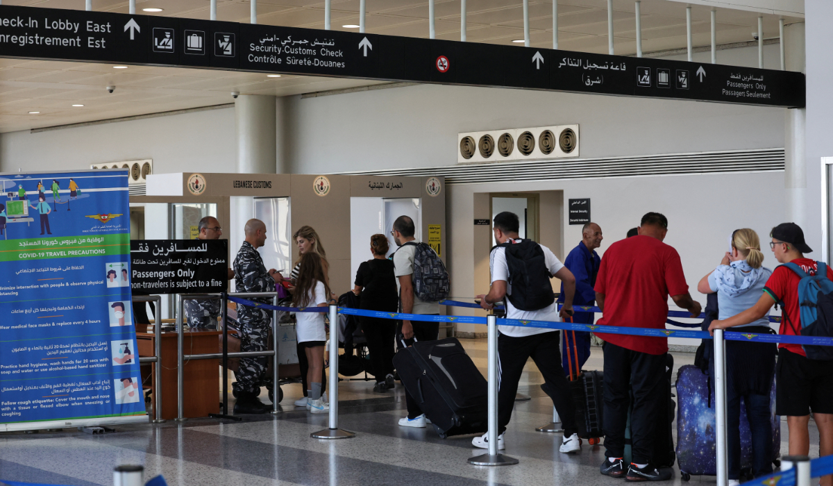 People wait in line at Lebanese customs at the Beirut–Rafic Hariri International Airport, in Beirut, Lebanon July 30, 2024. (REUTERS)