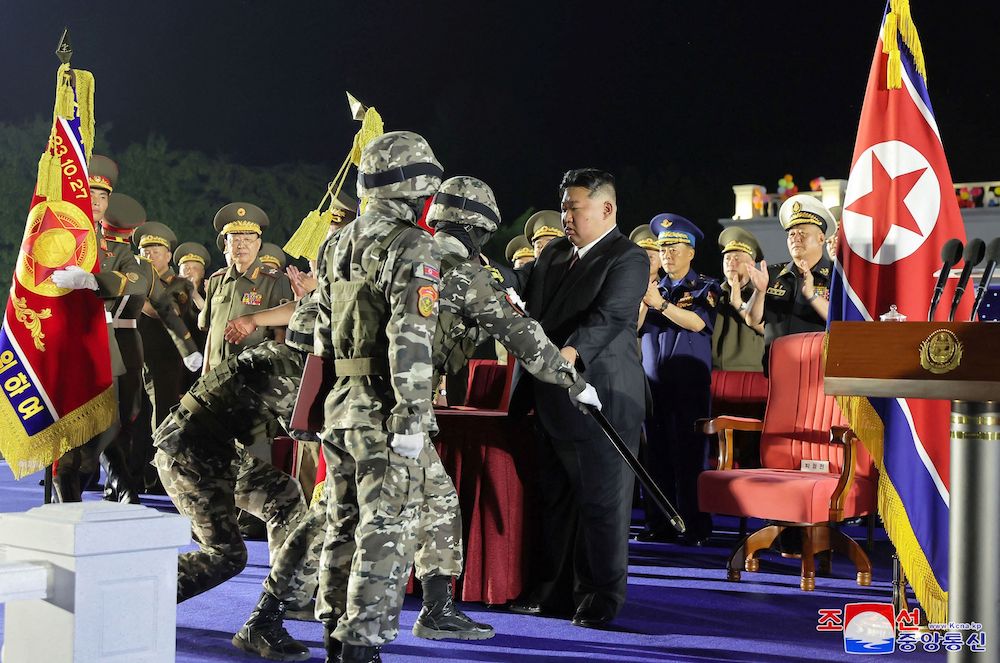 North Korean leader Kim Jong Un, center, attends a ceremony transferring new-type tactical ballistic missile launchers to the frontier military units in Pyongyang on Aug. 4, 2024. (KCNA/KNS via AFP)