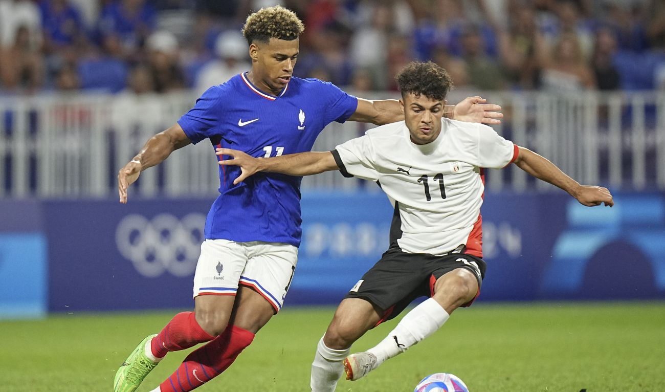 Egypt’s Mostafa Saad (R) and France’s Desire Doue battle for the ball during the men’s semifinal soccer match between France and Egypt, at Lyon Stadium, during the 2024 Summer Olympics, Monday, Aug. 5, 2024, in Decines, France. (AP)