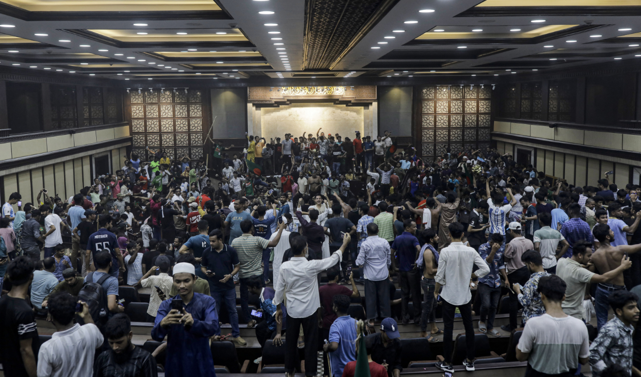 Anti-government protestors gather to vandalise Prime Minister Sheikh Hasina's palace in Dhaka on August 5, 2024. (AFP)
