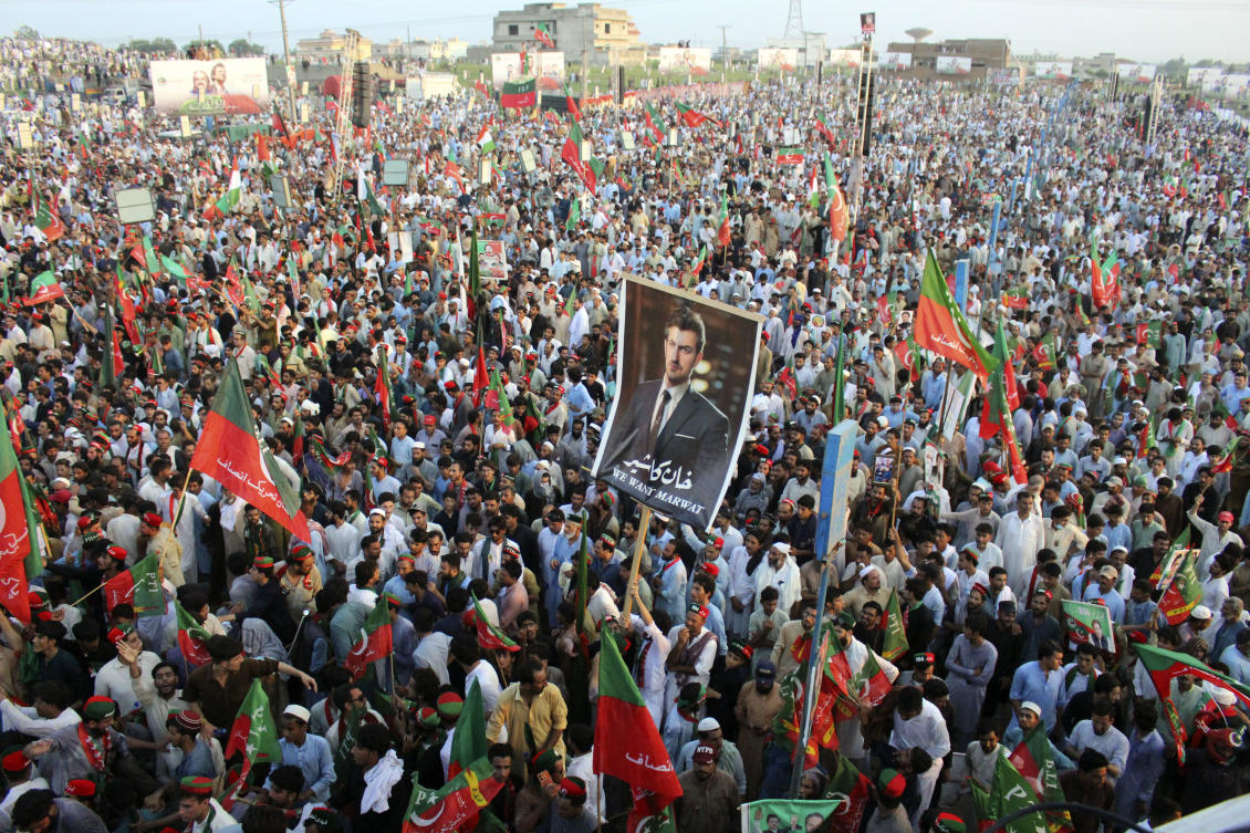 More than 10,000 supporters of Imran Khan were seen waving the party’s flags and chanting slogans in his favor in Swabi. (AP)