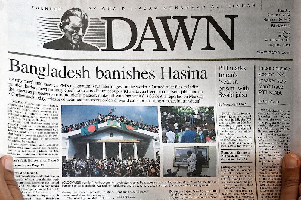 A man reads the front page of a newspaper in Islamabad on Aug. 6, 2024, a day after Bangladesh’s Prime Minister Sheikh Hasina was ousted by anti-government protestors. (AFP)