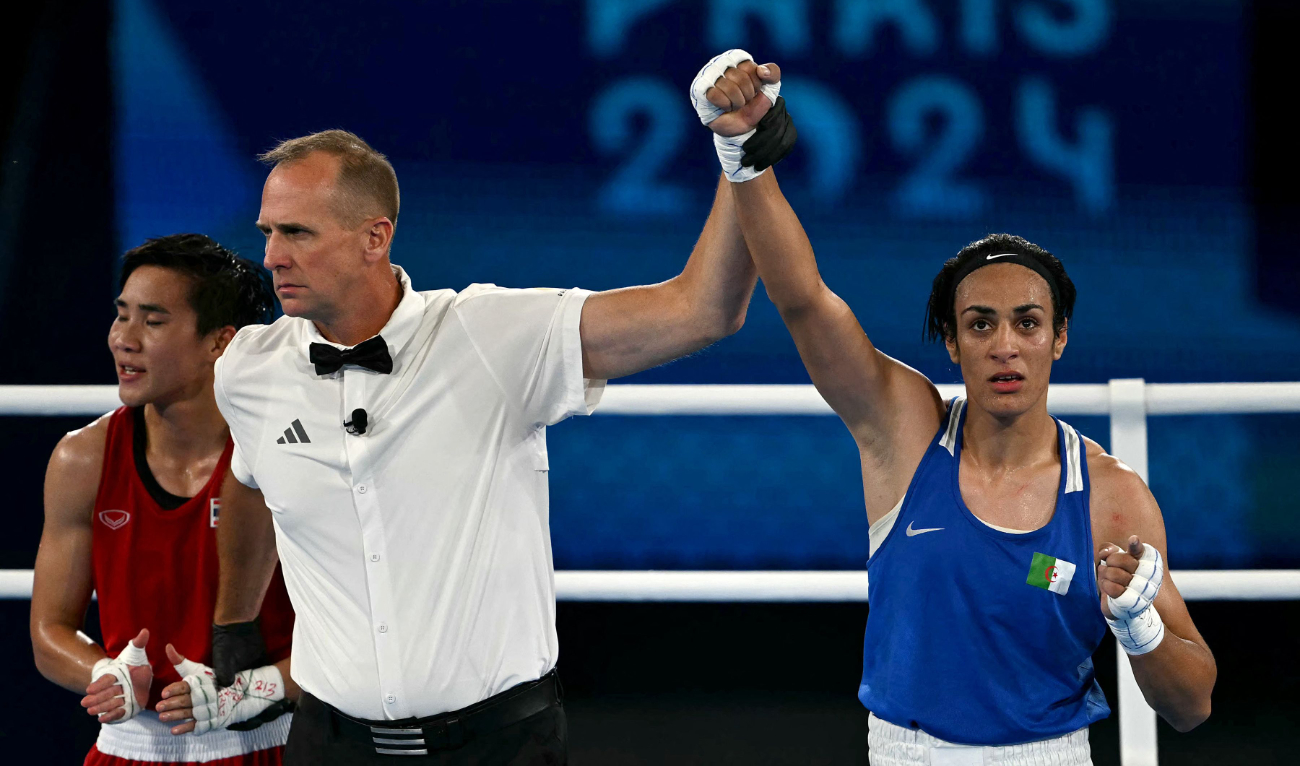 Algeria's Imane Khelif has her hands raised by the referee after beating Thailand's Janjaem Suwannapheng in the women's 66kg semifinal boxing match during the Paris 2024 Olympic Games at the Roland-Garros Stadium in Paris on Aug. 6, 2024. (AFP)