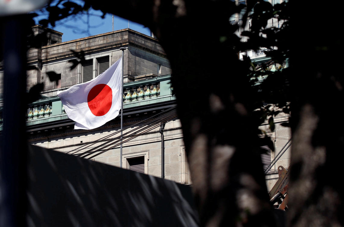 FILE PHOTO: A Japanese flag flutters a top building under construction in Tokyo. (REUTERS)