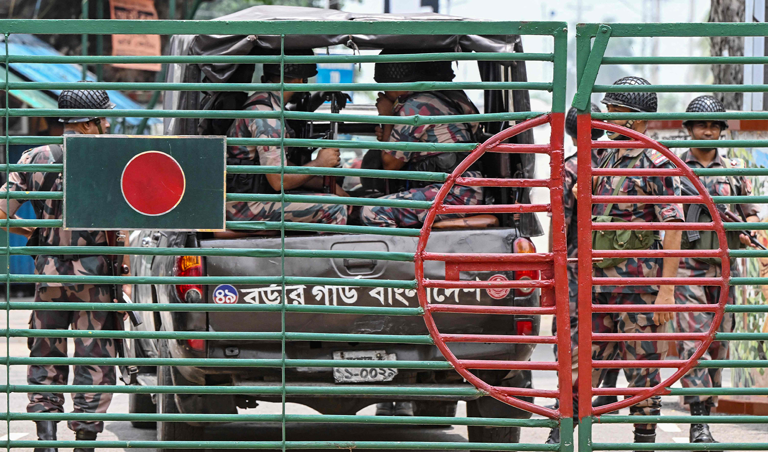 Border Guard Bangladesh (BGB) personnel stand guard at the India-Bangladesh border of Petrapole about 100km north-east of Kolkata on August 6, 2024. (AFP)