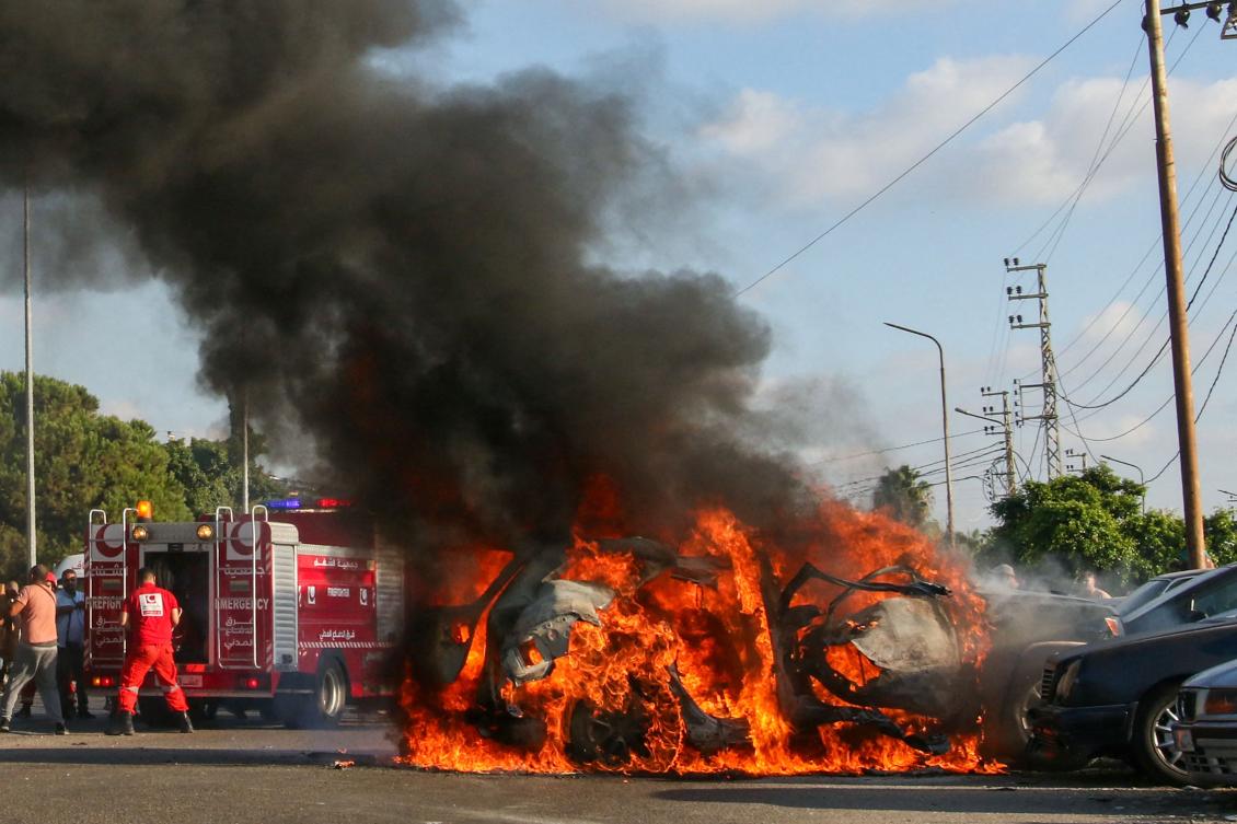 Firefighter arrive as a car burns following an Israeli strike in the southern Lebanese city of Sidon on Aug. 9, 2024. (AFP)