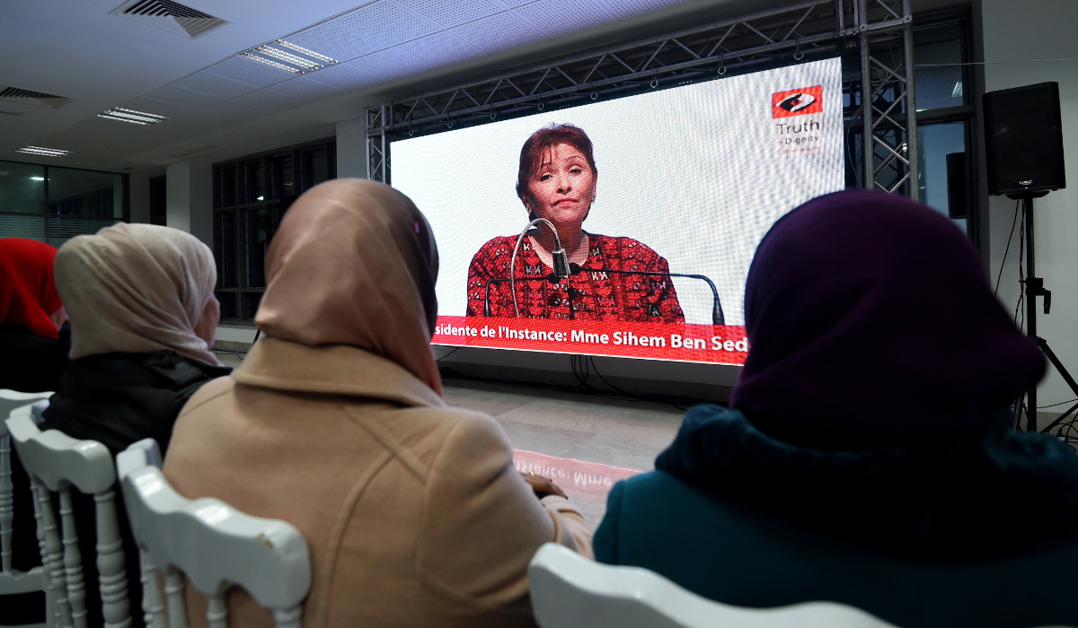 Sihem Bensedrine, head of the Truth and Dignity Commission (IVD), takes part in an open forum as relatives of abuse victims watch a live broadcast of testimonials by the victims before the IVD in Tunis on December 16, 2016. (AFP)
