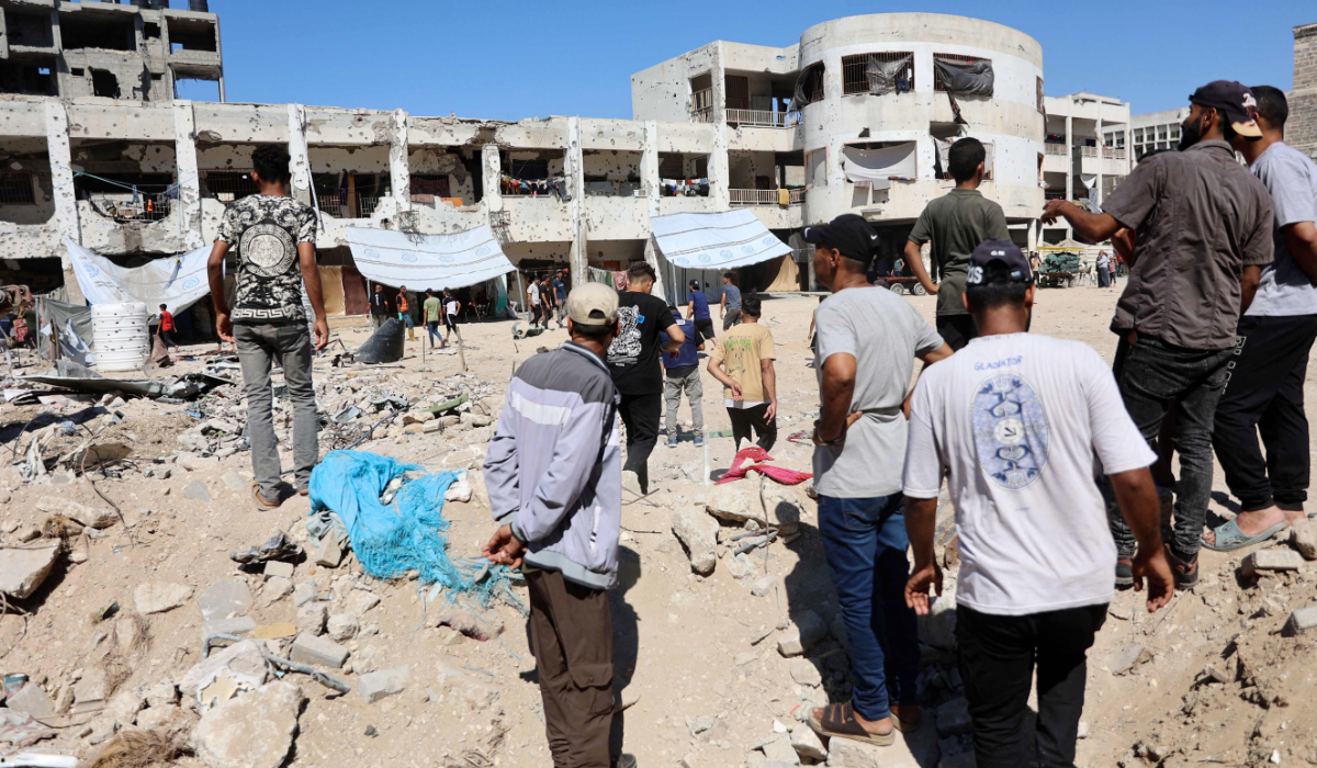 Palestinians check the damage in the al-Zahra school used as a refuge by displaced Palestinians following an Israeli strike, in the Shujaiya neighbourhood of Gaza City on August 8, 2024, amid the ongoing conflict between Israel and the militant group Hamas. (AFP)