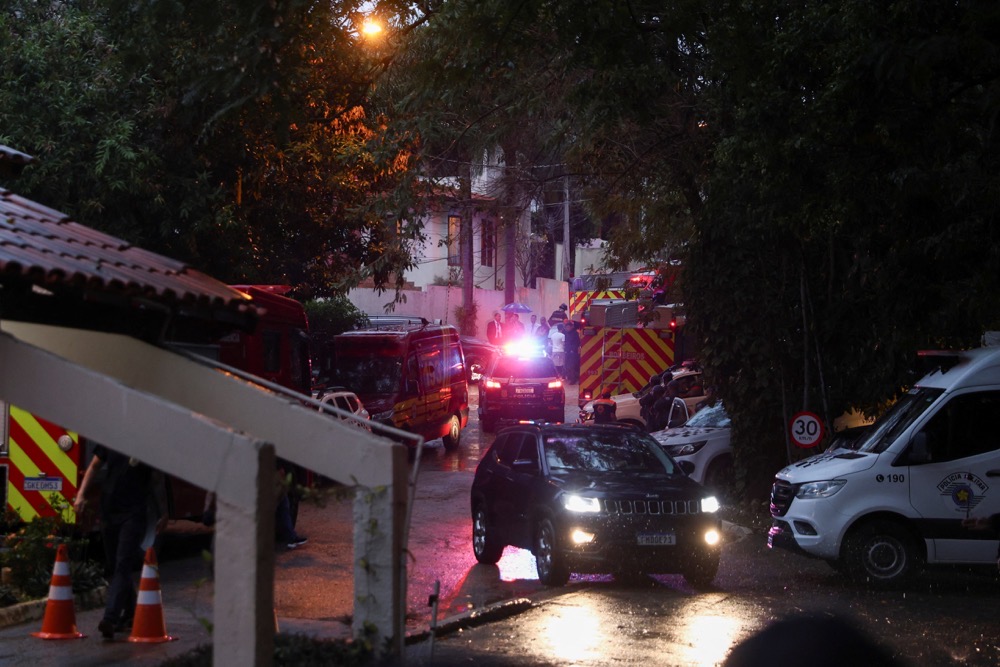 Authorities arrive at the site where a turboprop plane crashed killing all passengers and crew on board, in Vinhedo, Brazil. (Reuters)