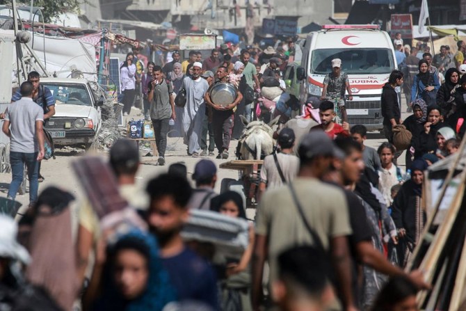 Displaced Palestinians leave an area in east Khan Yunis towards the west, after the Israeli army issued a new evacuation order for parts of the city, in the southern Gaza Strip on August 8, 2024, amid the ongoing conflict between Israel and the Palestinian Hamas militant group. (AFP)