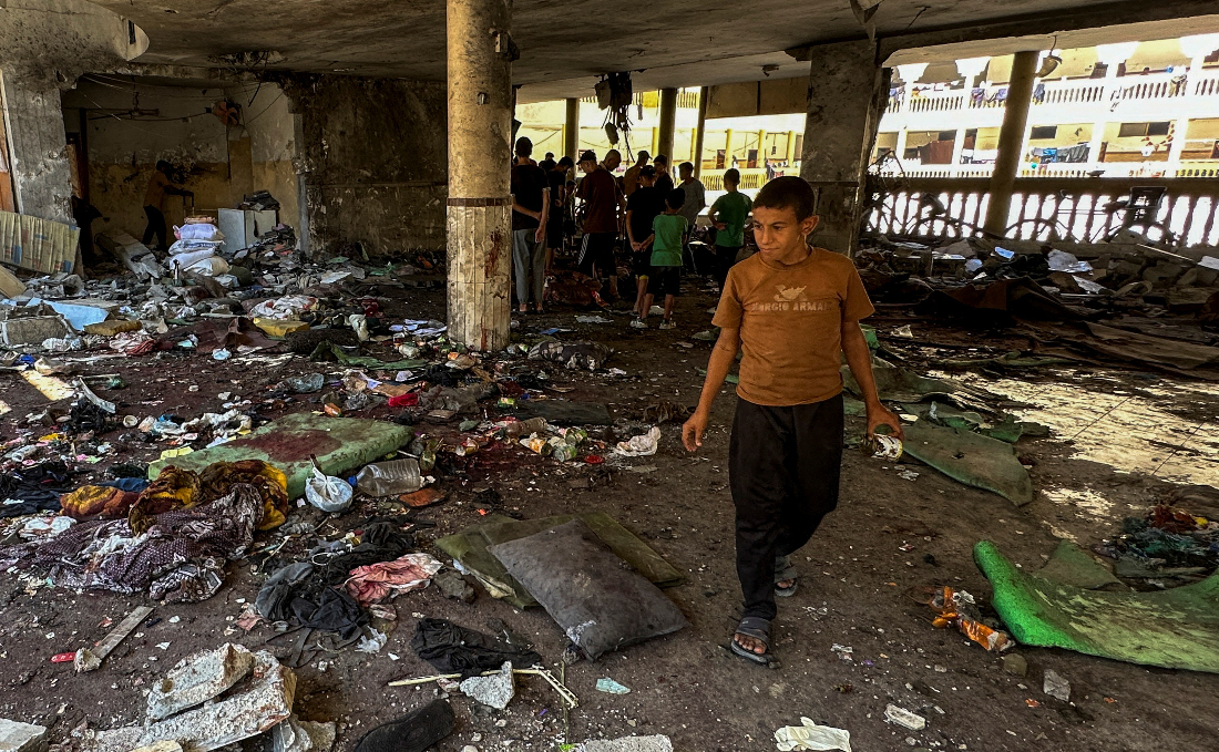 Palestinians look at damages at the site of an Israeli strike on a school sheltering displaced people, amid the Israel-Hamas conflict, in Gaza City. (Reuters)