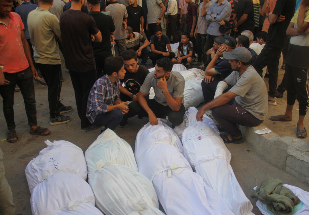 People react near bodies of Palestinians killed in an Israeli strike on a school sheltering displaced people, amid the Israel-Hamas conflict at a hospital in Gaza City on Aug. 10, 2024. (Reuters)