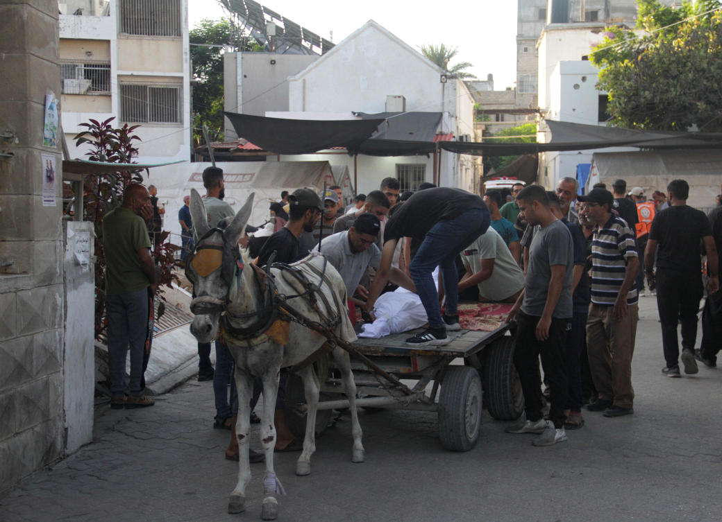 Bodies of Palestinians killed in an Israeli strike on a school sheltering displaced people, amid the Israel-Hamas conflict are transported on an animal-drawn cart at a hospital in Gaza City Aug. 10, 2024. (Reuters)