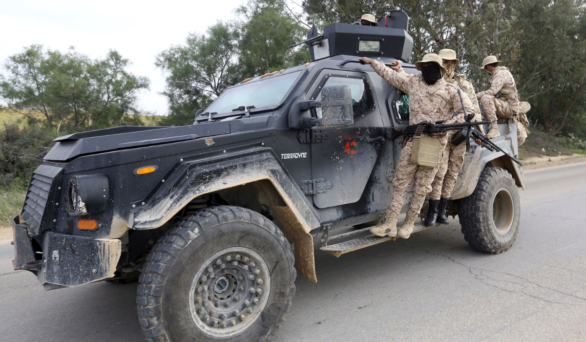 Members of the Tripoli Protection Force, an alliance of militias from the capital city, patrol an area south of the Libyan capital on January 18, 2019, during clashes with the Seventh Brigade group from the town of Tarhuna. (AFP)