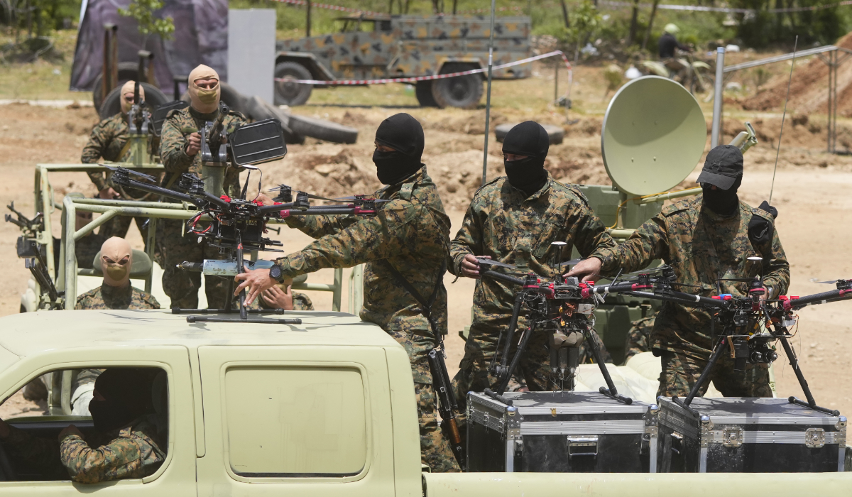 Hezbollah militants take part in a military exercise with armed drones in Aaramta village in the Jezzine District, southern Lebanon, on May 21, 2023. (AP)