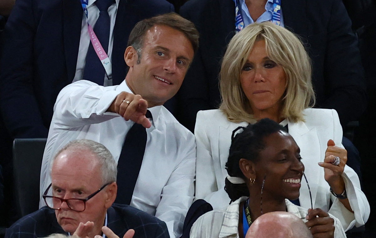 French President Emmanuel Macron and his wife, Brigitte Macron, during the US-France fight for the Paris 2024 Olympics basketball men's gold medal game at the Bercy Arena in Paris on August 10, 2024. (Reuters)