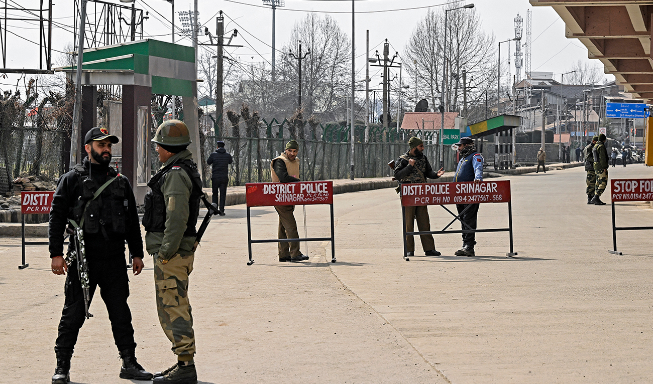 Indian security personnel stand guard on a blocked road ahead of the public rally by India’s Prime Minister Narendra Modi, in Srinagar on March 7, 2024. (AFP/File)