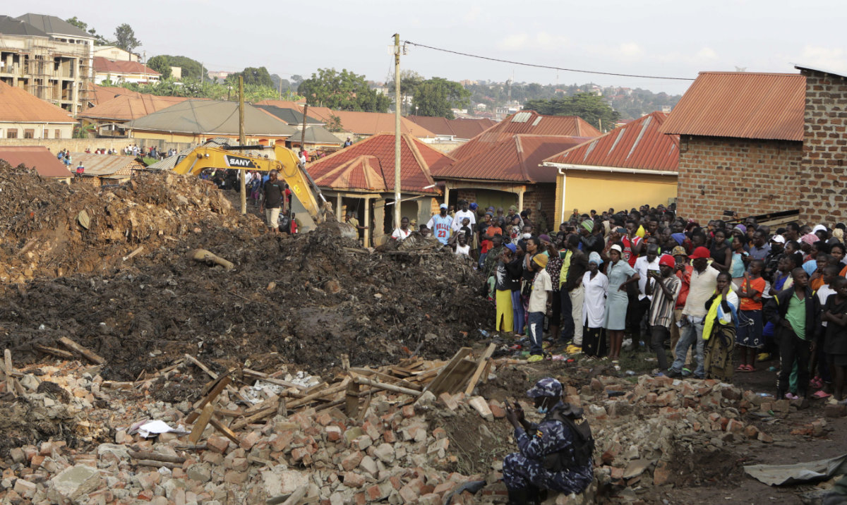 Onlookers watch as workers search for survivors at the site of a collapsed landfill in Kampala, Uganda, Sunday, Aug. 11, 2024. (AP)
