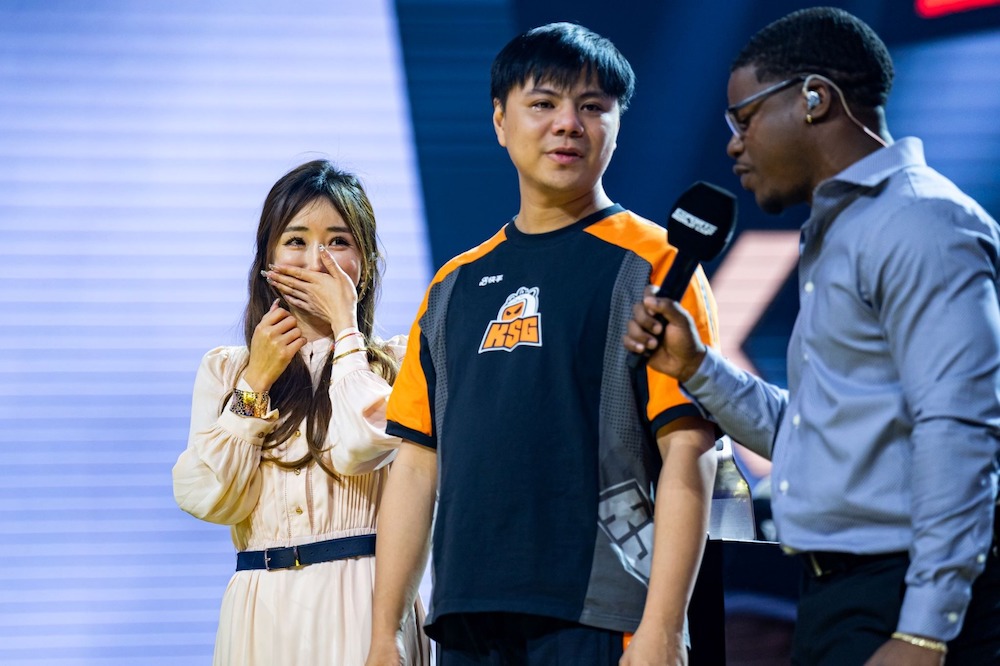 Chinese player Xiao Hai wept with joy after his wife Elena ran on stage to celebrate with him following his 5-2 triumph over Kawano in the Street Fighter 6 final. (Supplied)