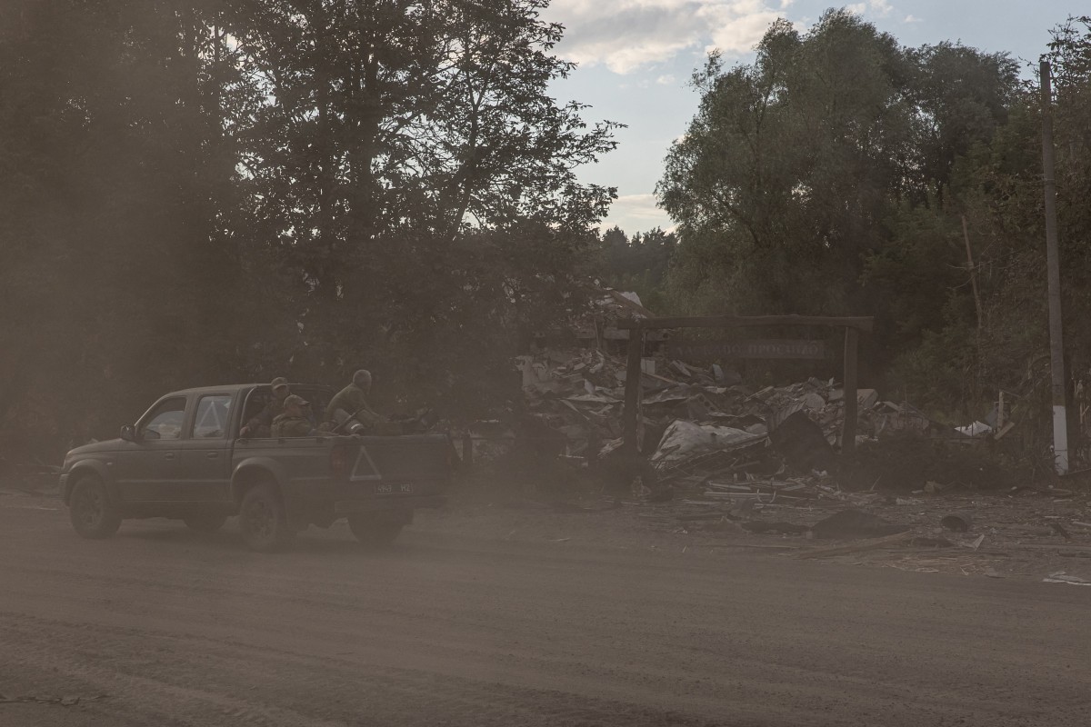 Ukrainian servicemen sitting in a military vehicle drive past a destroyed building by shelling in the Sumy region, near the border with Russia, on August 11, 2024, amid the Russian invasion of Ukraine. (File/AFP)