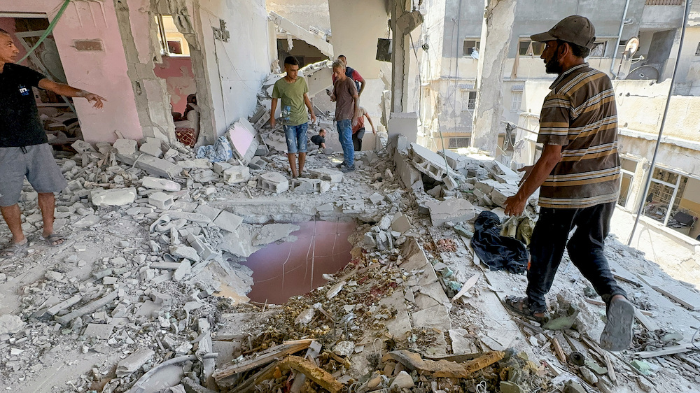 Palestinians inspect the site of an Israeli strike on a house in Gaza City on Aug. 12, 2024. (Reuters)