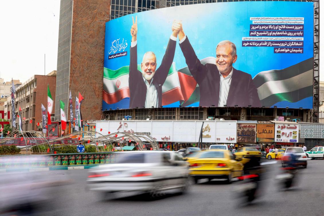Above, a huge billboard depicts Iranian President Masoud Pezeshkian, right, and slain Palestinian Hamas leader Ismail Haniyeh at Tehran’s Valiasr Square on Aug. 12, 2024. (AFP)