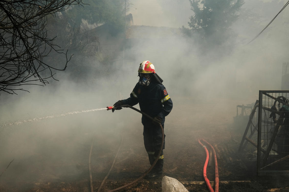A firefighter tries to extinguish a wildfire burning in Nea Penteli, Greece, August 12, 2024. (Reuters)