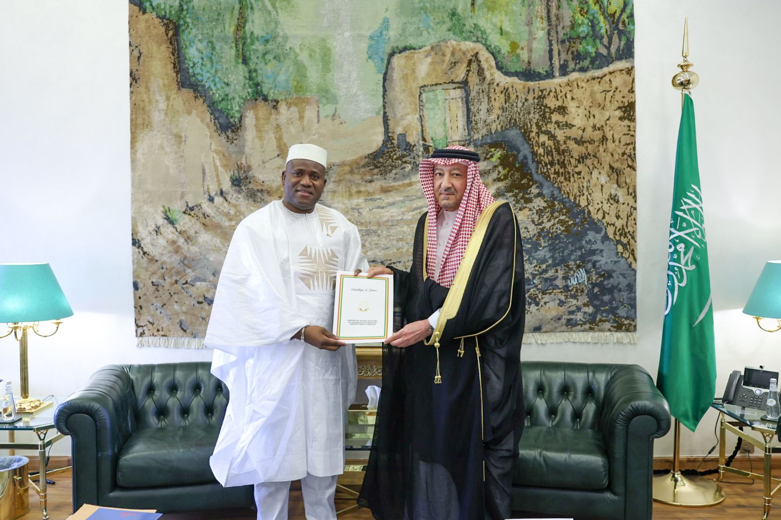 Guinea’s Minister of Planning and International Cooperation Ismael Nabe hands over the letter to Saudi Deputy Foreign Minister Waleed Al-Khuraiji during a meeting in Riyadh. (SPA)