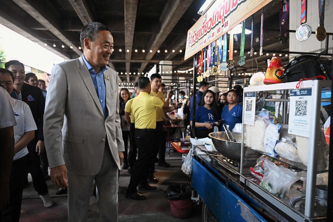 Thailand’s Prime Minister Srettha Thavisin visits a food market in Bangkok on Aug. 14, 2024. Srettha denies wrongdoing in appointing to cabinet former Shinawatra lawyer Pichit Chuenban. (AFP)