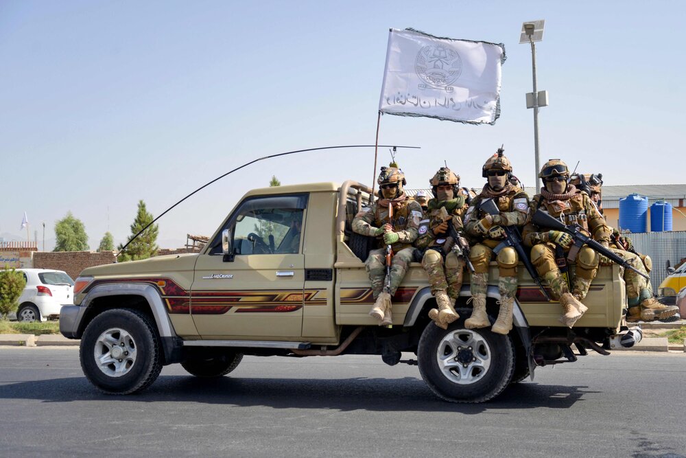 Taliban security personnel of Afghanistan military’s 205 Al-Badr Corps sit atop a military vehicle during a parade to celebrate the third anniversary of Taliban’s takeover of the country, in Kandahar on August 14, 2024. (AFP)