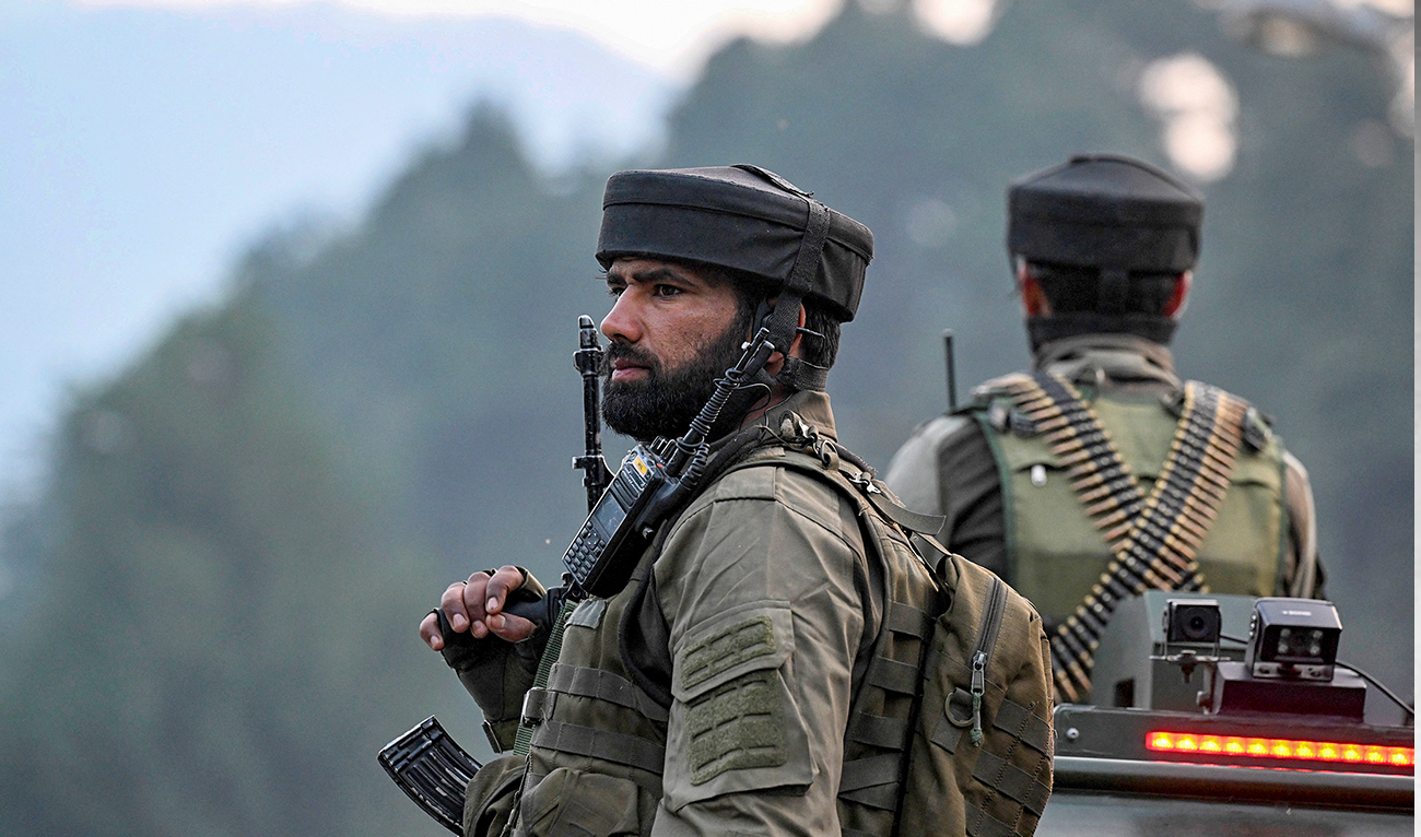 Security personnel stand guard as Hindu devotees begin their pilgrimage to the cave shrine of Amarnath from a base camp in Pahalgam on June 29, 2024. (AFP/File)