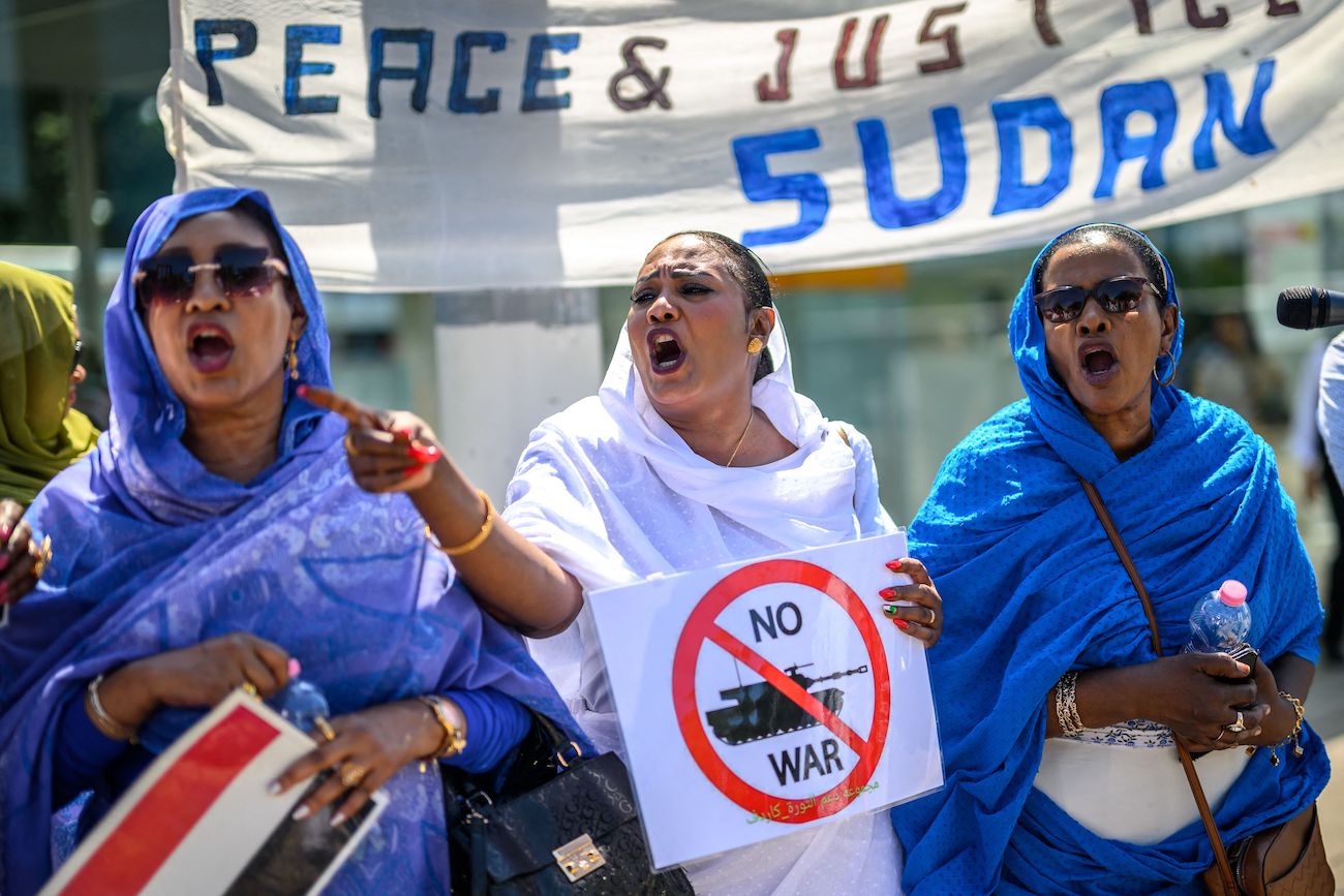 Women shout slogans as they take part in a demonstration on the opening day of Sudan ceasefire talks in Geneva, on August 14, 2024. (AFP)
