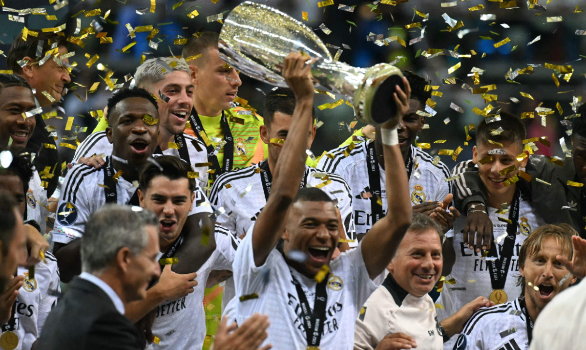 Real Madrid's French forward #09 Kylian Mbappe celebrates with the trophy after the UEFA Super Cup football match between Real Madrid and Atalanta BC in Warsaw, on August 14, 2024. (AFP)