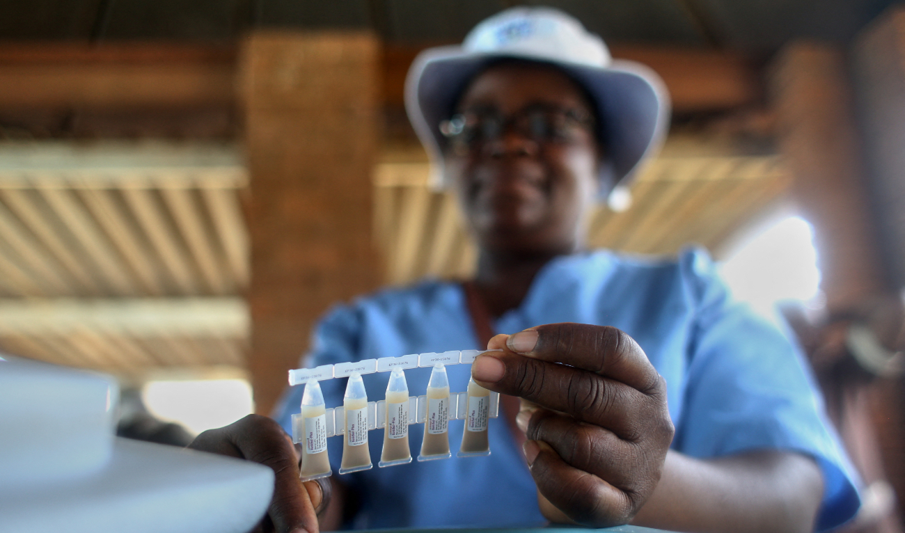 A health worker holds up a sample of the cholera vaccines available during the launch of a campaign to immunise people with a cholera vaccine in affected areas, at the Kuwadzana Polyclinic in Harare on January 29, 2024. (AFP)