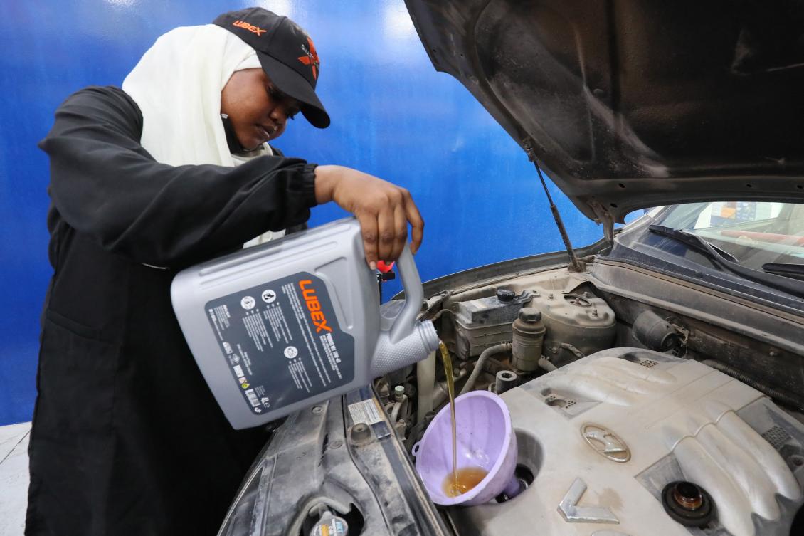 Sudanese mechanic Asawar Mustafa works on a car in the women-only section of a garage in the northwestern Libyan city of Misrata, on July 31, 2024.(AFP)