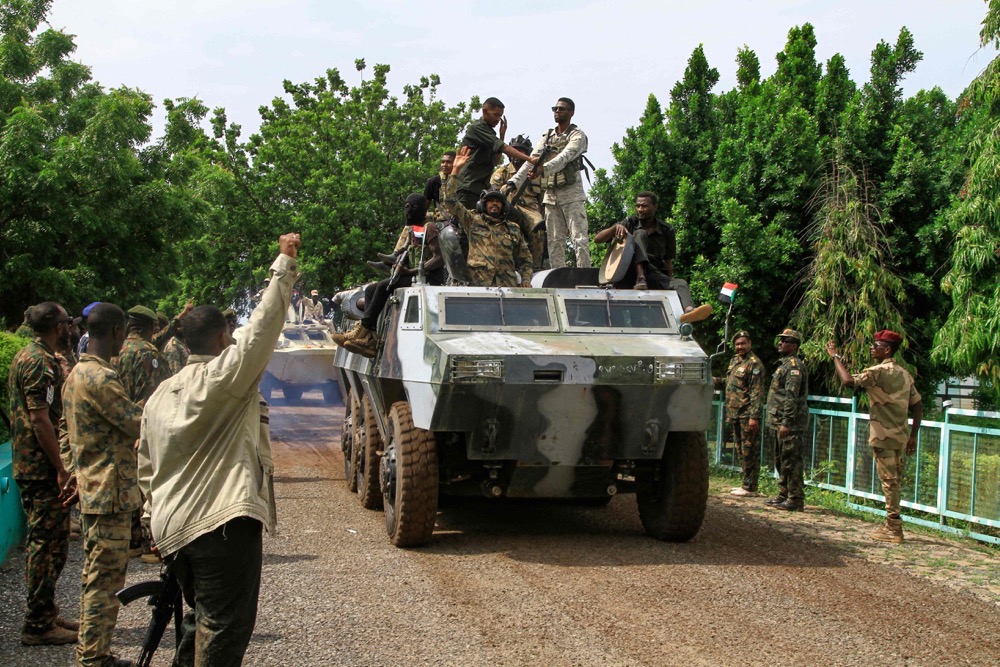 People cheer members of Sudan's armed forces taking part in a military parade held on Army Day in Gadaref on August 14, 2024. (AFP)